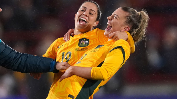 Katrina Gorry (left) and Charlotte Grant celebrate after the Matildas' win over England.