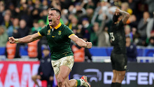 Jesse Kriel of South Africa celebrates following the team's victory while New Zealand's Rieko Ioane stands in disbelief behind him.