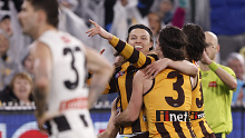 Hawk Jack Ginnivan celebrates one of his goals against Collingwood, taunting them by pointing to the scoreboard.