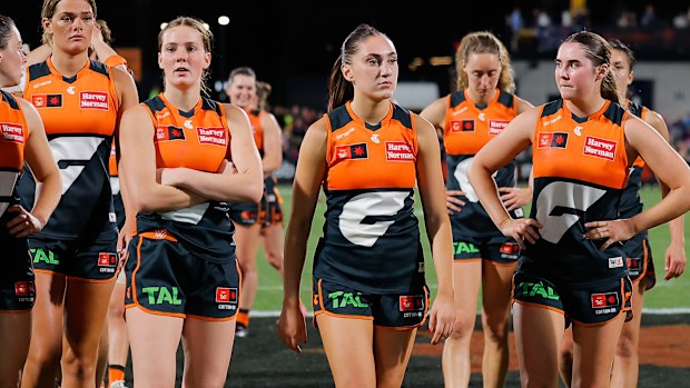 The GWS Giants AFLW team leave the field after a loss.