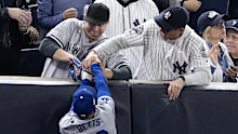 Two fans who interfered with a player have been banned from attending the next World Series game.