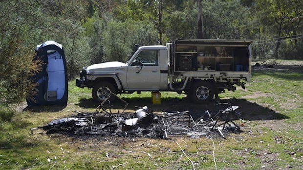Tendered photos of Russell Hill and Carol Clay's burnt-out campsite were shown to the jury.