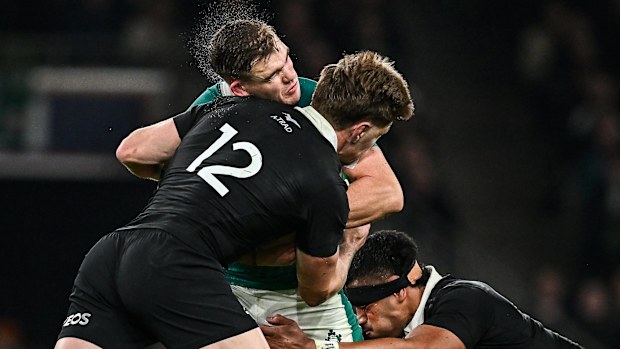Garry Ringrose of Ireland is tackled by Jordie Barrett of New Zealand.