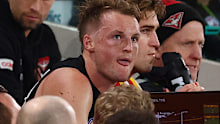 MELBOURNE, AUSTRALIA - JULY 17: Mason Redman of the Bombers sits on the bench during the round 19 AFL match between Essendon Bombers and GWS Giants at Marvel Stadium on July 17, 2025 in Melbourne, Australia. (Photo by Morgan Hancock/Getty Images)