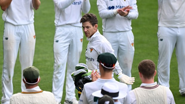 Tim Paine is acknowledged by players as he leaves the field during the Sheffield Shield match between Tasmania and Queensland.