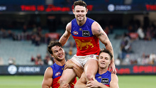 MELBOURNE, AUSTRALIA - APRIL 11: Lachie Neale of the Lions is chaired from the field by teammate Cam Rayner (left) and Lincoln McCarthy (right) after his 250th match during the 2024 AFL Round 05 match between the Melbourne Demons and the Brisbane Lions at the Melbourne Cricket Ground on April 11, 2024 in Melbourne, Australia. (Photo by Michael Willson/AFL Photos via Getty Images)
