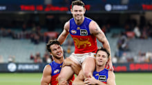 MELBOURNE, AUSTRALIA - APRIL 11: Lachie Neale of the Lions is chaired from the field by teammate Cam Rayner (left) and Lincoln McCarthy (right) after his 250th match during the 2024 AFL Round 05 match between the Melbourne Demons and the Brisbane Lions at the Melbourne Cricket Ground on April 11, 2024 in Melbourne, Australia. (Photo by Michael Willson/AFL Photos via Getty Images)