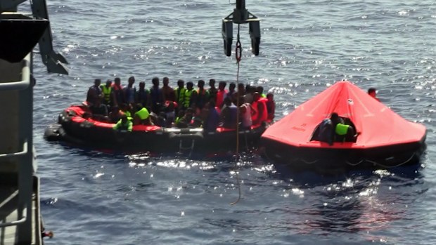 Some of migrants pulled from the water after their boat capsized off the Libyan coast. (AAP)