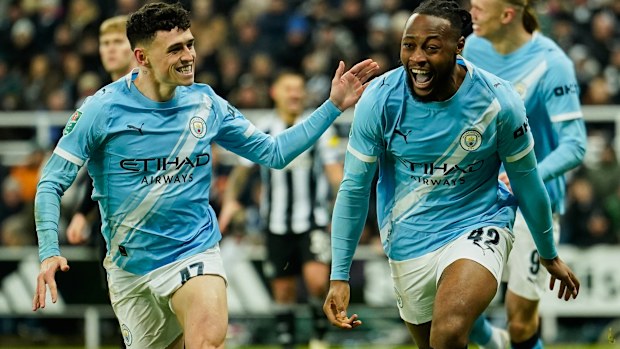 Manchester City's Antoine Semenyo, right, celebrates after scoring his side's opening goal during the English League Cup semi final.