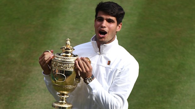 Carlos Alcaraz of Spain celebrates with the Gentlemen's Singles Trophy following victory against Novak Djokovic of Serbia in the Gentlemen's Singles Final during day fourteen of The Championships Wimbledon 2024 at All England Lawn Tennis and Croquet Club on July 14, 2024 in London, England. (Photo by Francois Nel/Getty Images)