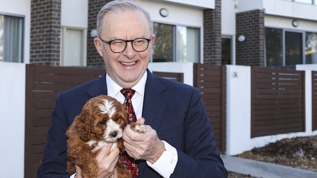 Prime Minister Anthony Albanese with homeowner Abbey Woods and her dog Chilli, after a visit to their home in the Canberra suburb of Lawson, on Monday 25 August 2025. 