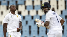 South Africa's Kagiso Rabada, left, reacts after runs are scored by India's KL Rahul.