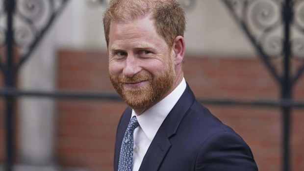 Prince Harry smiles towards the media as he leaves the Royal Courts of Justice in London, Tuesday, April 8, 2025