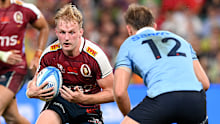 Tom Lynagh looks to take on the defence during the Super Rugby Pacific match between Queensland Reds and NSW Waratahs.