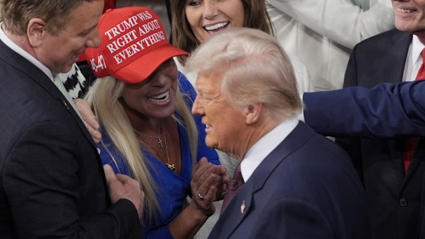 President Donald Trump arrives and walks by Rep. Marjorie Taylor Greene, R-Ga., to address a joint session of Congress at the Capitol in Washington, Tuesday, March 4, 2025. 