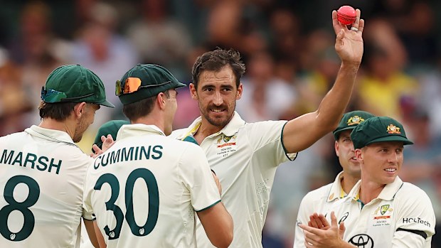 Mitchell Starc raises the pink ball during day one of the Men's Test Match series between Australia and India at Adelaide Oval.