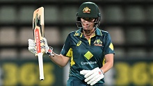 Beth Mooney celebrates scoring a half-century during game three of the women's T20I series between Australia and South Africa at Blundstone Arena.