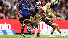 Tim Ryan of the Reds is tackled by Mark Tele'a of the Blues.