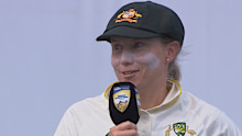 Alyssa Healy speaks on the podium.