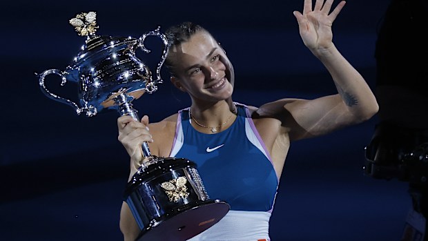 Aryna Sabalenka of Belarus waves as she holds the Daphne Akhurst Memorial Trophy.