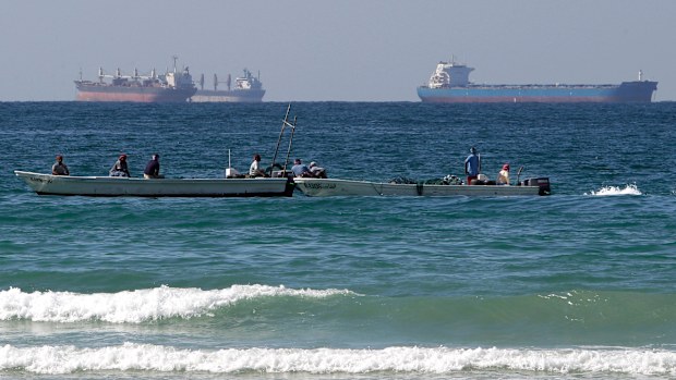 FILE - Fishermen work in front of oil tankers south of the Strait of Hormuz Jan. 19, 2012, offshore the town of Ras Al Khaimah in United Arab Emirates. (AP Photo/Kamran Jebreili, File)