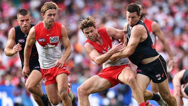 Dane Rampe of the Swans and Toby Greene of the Giants contest the ball.