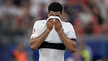 Jude Bellingham of England wipes sweat from his face during the UEFA EURO 2024 group stage match between Denmark and England at Frankfurt Arena on June 20, 2024 in Frankfurt am Main, Germany. (Photo by Visionhaus/Getty Images)