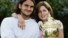 LONDON - JULY 6:  Men's Singles champion Roger Federer of Switzerland poses with his girlfriend Miroslava Vavrinec and the trophy after his victory over Mark Philippoussis of Australia in the Men's Singles Final during the final day of the Wimbledon Lawn Tennis Championships held on July 6, 2003 at the All England Lawn Tennis and Croquet Club, in Wimbledon, London. (Photo by Phil Cole/Getty Images)