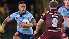 Spencer Leniu charges into the Queensland defence.