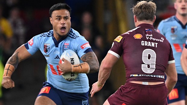 Spencer Leniu charges into the Queensland defence.