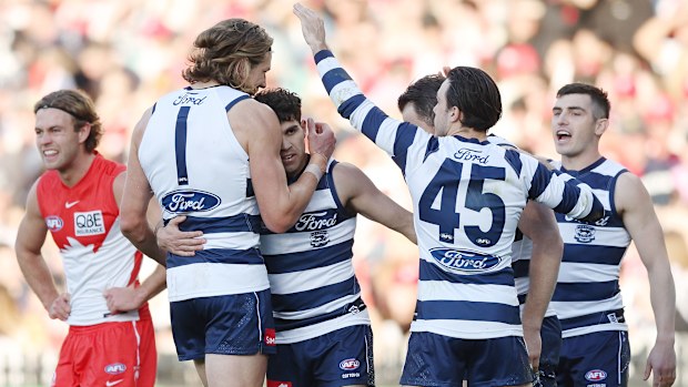 Tyson Stengle of the Cats celebrates kicking a goal.