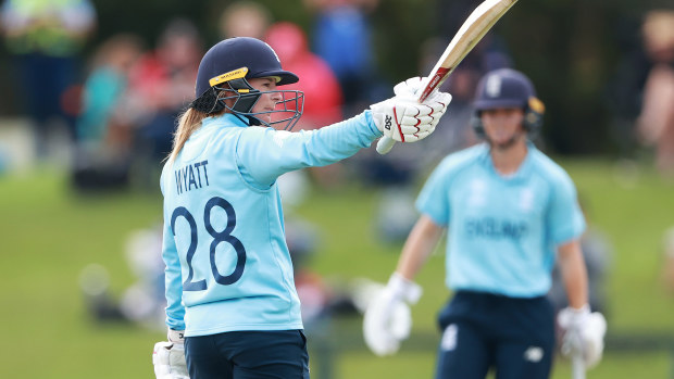 England's Danielle Wyatt raises her bat after scoring a half century.
