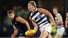 Tanner Bruhn of the Cats handpasses the ball during the 2026 AFL AAMI Community Series.