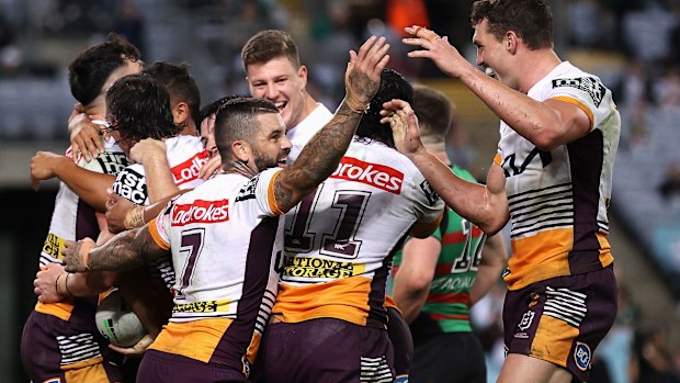 Herbie Farnworth of the Broncos celebrates a try with teammates during their round nine win over the Rabbitohs.