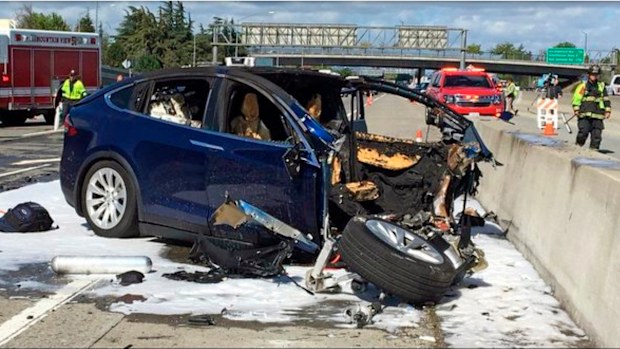 Emergency personnel work a the scene where a Tesla electric SUV crashed into a barrier on U.S. Highway 101 in California.