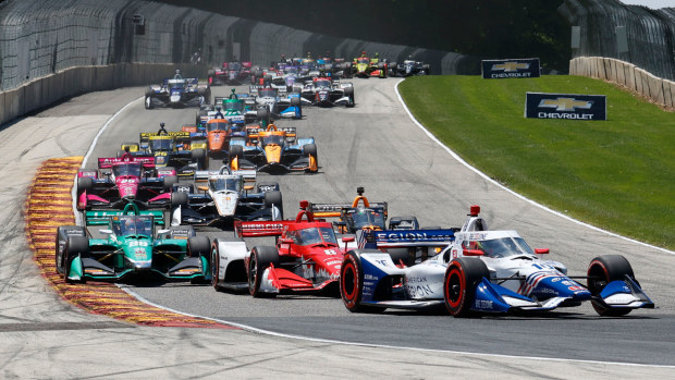 NTT IndyCar series driver Alex Palou (10) leads a pack of cars into turn 5 during the Sonsio Grand Prix at Road America.
