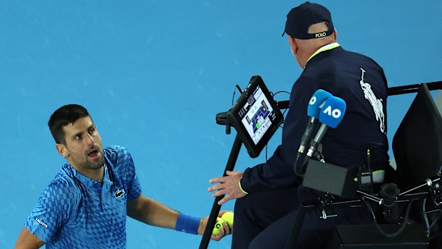 Novak Djokovic of Serbia talks to chair umpire Fergus Murphy at Melbourne Park.