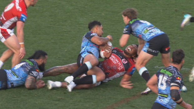 Moses Suli suffers a knee injury during a tackle.