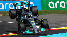 Lewis Hamilton's car is sprung into the air after contact with Fernando Alonso.