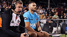 Robbie Farah and other Tigers support staff watch from the bench.