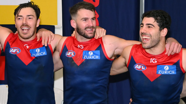 (From left) Michael Hibberd, Joel Smith and Christian Petracca of the Demons sings after winning the round 13 AFL match between Melbourne Demons and Collingwood Magpies.