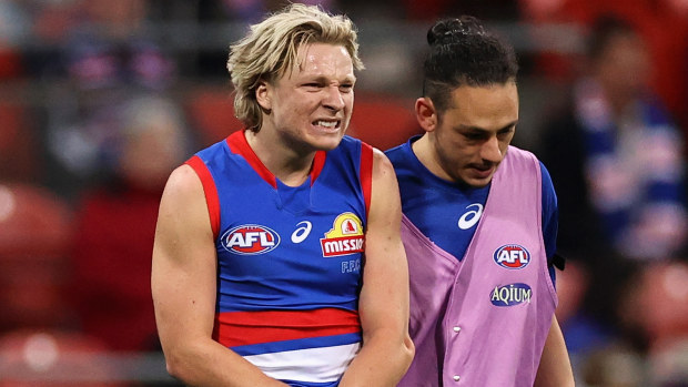 Cody Weightman of the Bulldogs leaves the field with a dislocated elbow duing the round 14 AFL match between the GWS Giants and the Western Bulldogs. Photo: Cameron Spencer
