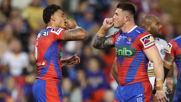 Will Pryce celebrates scoring his maiden NRL try with Knights' teammate Bradman Best.