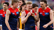 Jake Lever (right) drags teammate Clayton Oliver away from a wrestle during the round 23 AFL match between Melbourne Demons and Hawthorn Hawks at Melbourne Cricket Ground, on August 20, 2023, in Melbourne, Australia. 