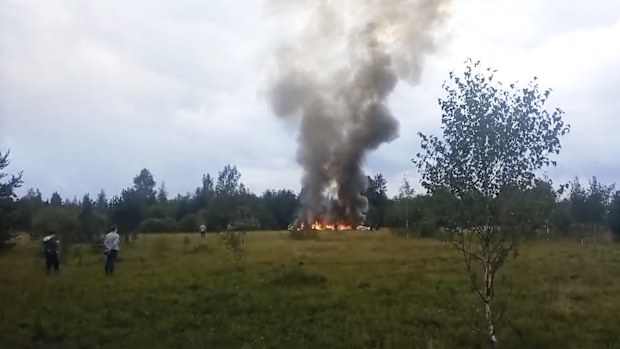 Smoke and flames rise from a crashed private jet near the village of Kuzhenkino, Tver region, Russia, Wednesday, Aug. 23, 2023