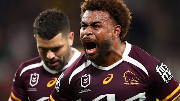 Ezra Mam of the Broncos celebrates a try with Adam Reynolds in the background.