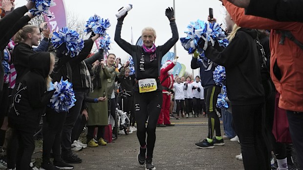 Belgian ultra runner Hilde Dosogne is cheered on as she crosses the finish line during her 366th consecutive marathon.