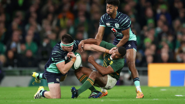 Dan Sheehan and Robert Baloucoune of Ireland battle for possession with Damian Willemse of South Africa in the 2022 Autumn International series.