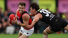 BALLARAT, AUSTRALIA - FEBRUARY 28: Zach Merrett of the Bombers breaks the tackle of Hugh Boxshall of the Saints during the 2026 AFL AAMI Community Series match between the St Kilda Saints and the Essendon Bombers at Mars Stadium on February 28, 2026 in Ballarat, Australia. (Photo by James Wiltshire/AFL Photos via Getty Images)