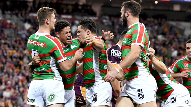 The Rabbitohs celebrate a try against the Broncos.